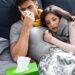 couple in bed sick with lack of energy after flu
